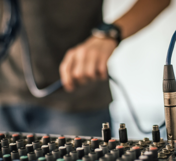 Person plugging in cords for audio