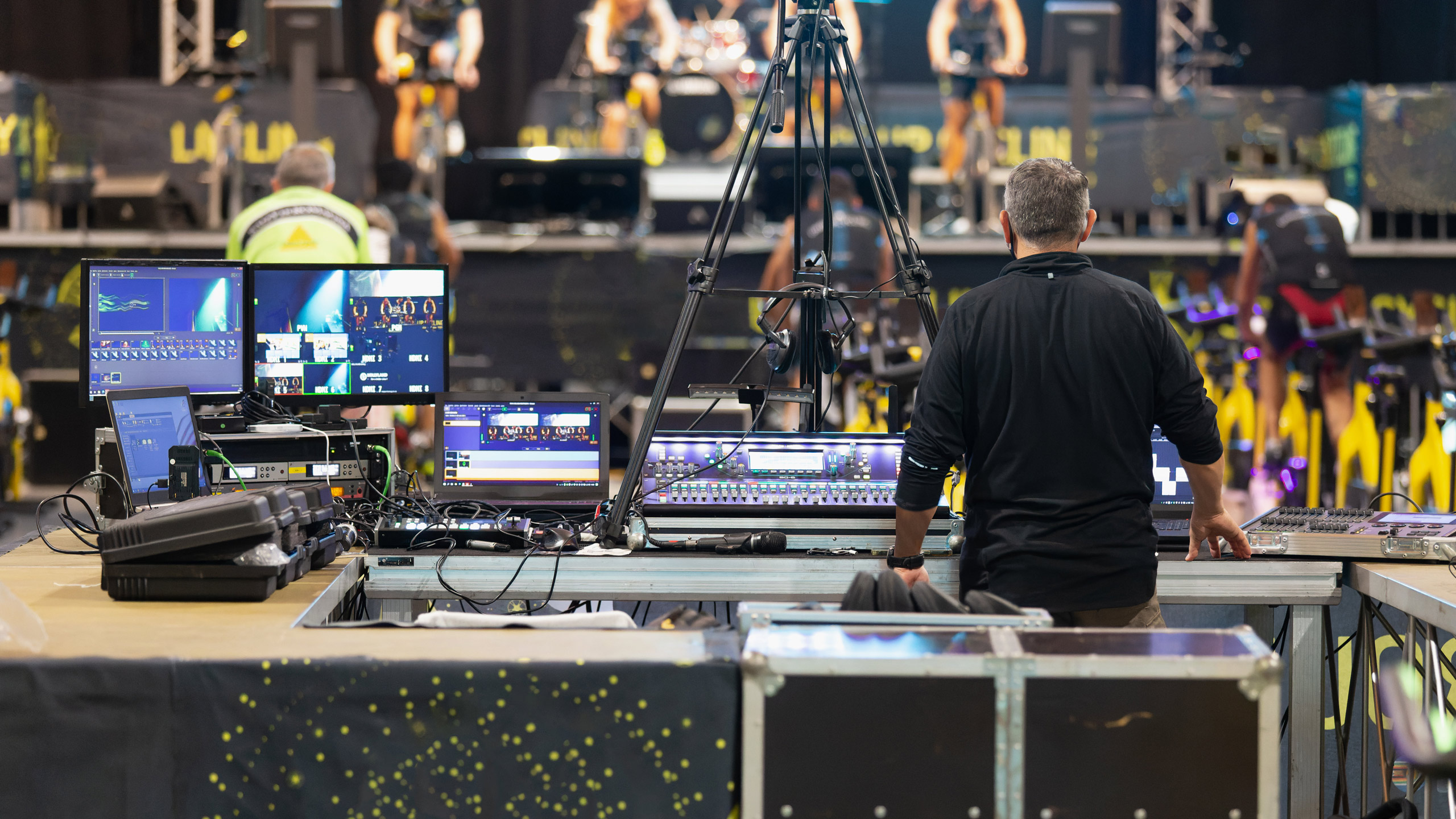 A man working at an event in Las Vegas to ensure audio and visual elements are properly executed.
