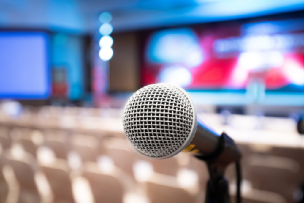 Closeup of microphone facing audience of a conference stage