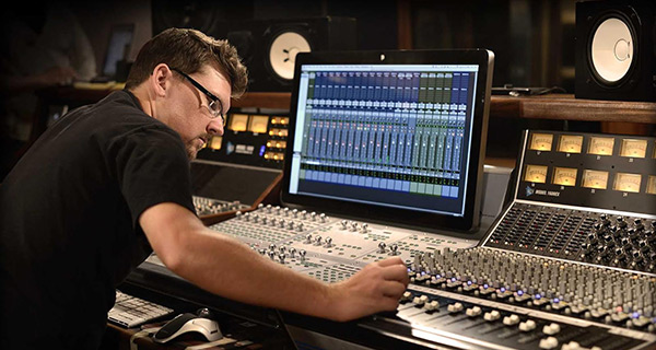 A Service Audio Engineer Working at his Audio Station