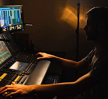 A Lights Engineer Infront of a Control Unit