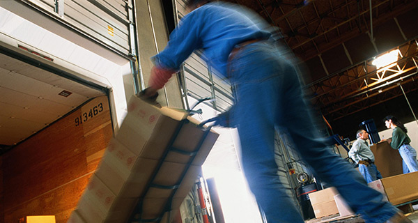 A Man Unloading Packages From an Open Truck